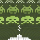 Retro pixel art of green alien faces.