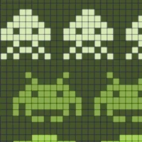 Close-up of pixelated alien formations and player cannon from Space Invaders gameplay.