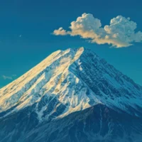 Detailed view of Mount Fuji’s snowy peak under an evening sky.